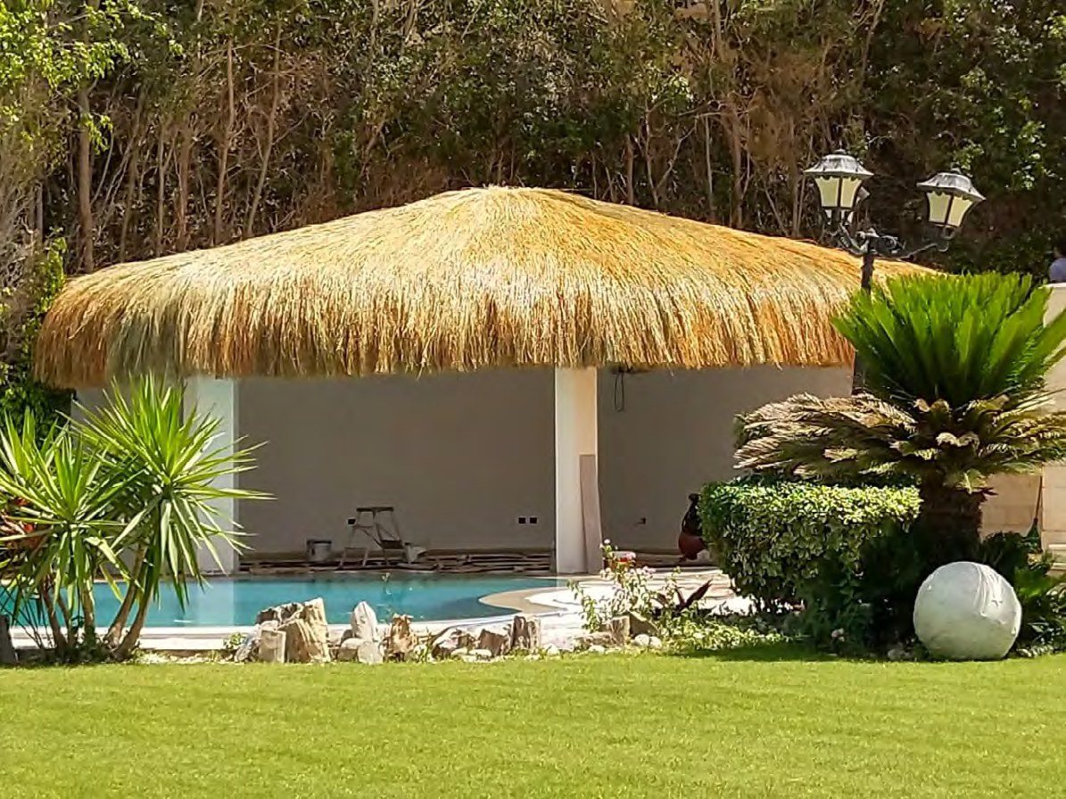 Thatch pergola beside a private pool